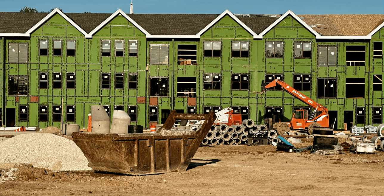Active construction site with excavator and building materials – builder's risk insurance Nebraska | CRS Group