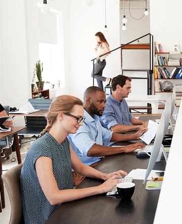Employees working at computers in an office – employee benefits and group health insurance Nebraska | CRS Group