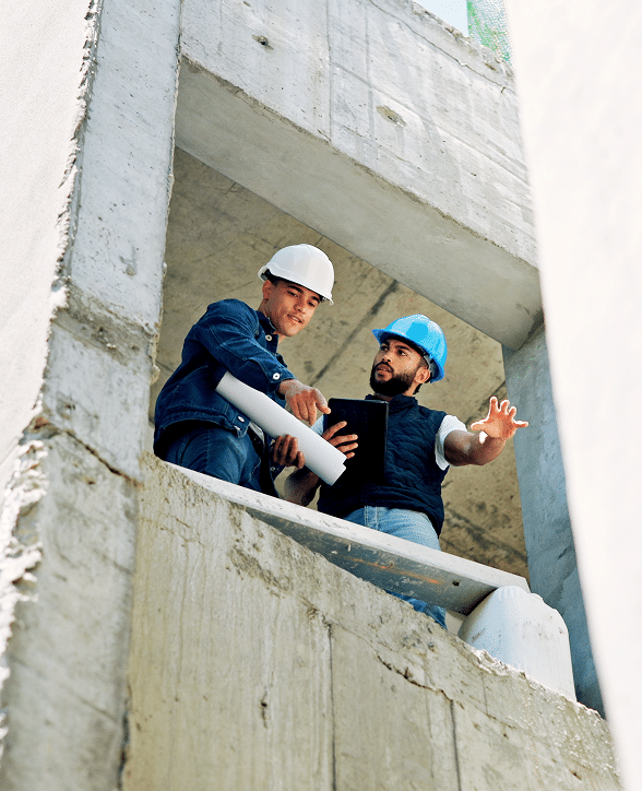 Two contractors in hard hats inspecting a concrete structure – surety bonds Nebraska | CRS Group