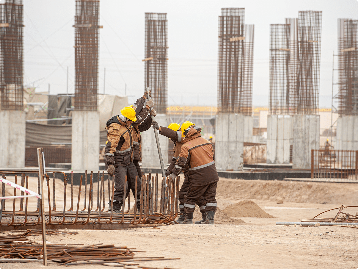 Construction workers in hard hats working on a job site – CRS Group